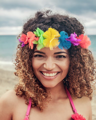 Beautiful Hawaiian woman portrait smiling widely and wearing colorful garland
