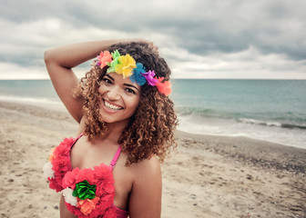 Beautiful Hawaiian woman portrait smiling widely near the sea