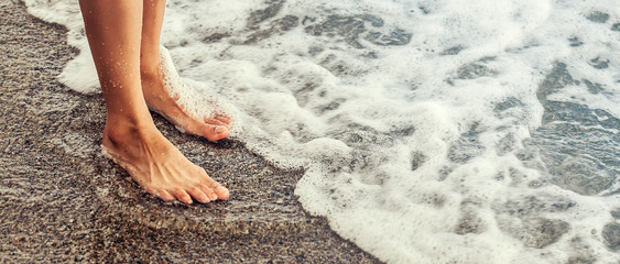 Female feet and seashore, woman going to bath in the sea, letterbox - obrazy, fototapety, plakaty