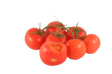 The bitten off tomato and tomatoes on a branch on a white background