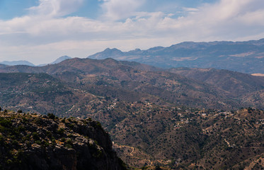beautiful view of the mountains in the region of Andalusia, houses and farmland on the slopes of mountains