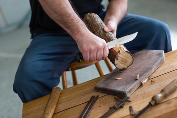 man making three tealight candle holders from rustic wood