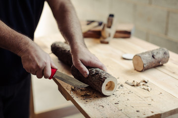 man making three tealight candle holders from rustic wood