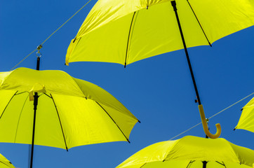 Colourful umbrellas urban street decoration. Hanging colorful umbrellas over blue sky, tourist attraction