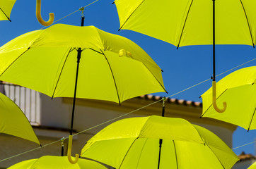 Colourful umbrellas urban street decoration. Hanging colorful umbrellas over blue sky, tourist attraction