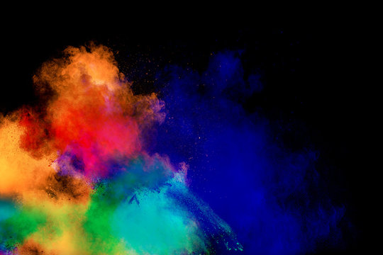 Multi color powder explosion isolated on black background.