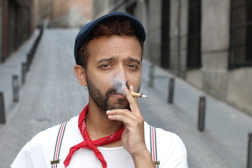 Stylish ethnic man smiling outdoors 
