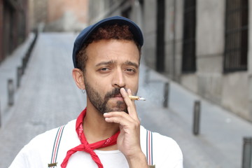 High looking male smoking on the street