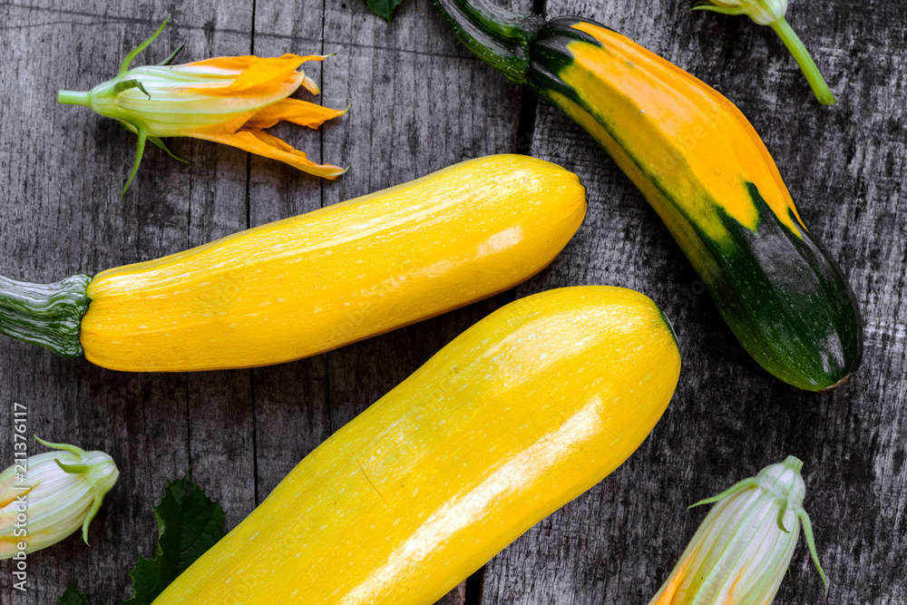 Wall mural fresh young yellow zucchini. vegetarian background.