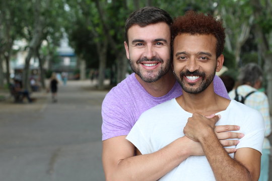 Interracial gay couple outdoor close up 