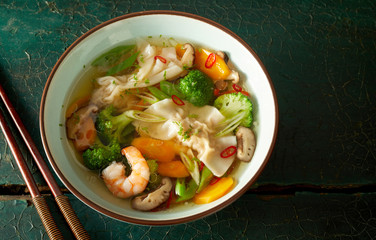 Bowl of Chinese wonton soup with dumplings