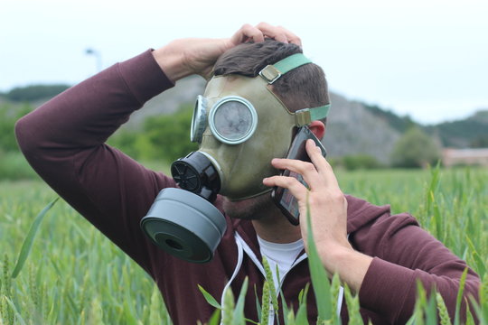 Worried man with breathing mask calling from nature