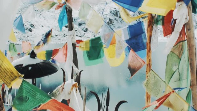 prayer flags Lungta in the temple near the winter lake in the Himalayas