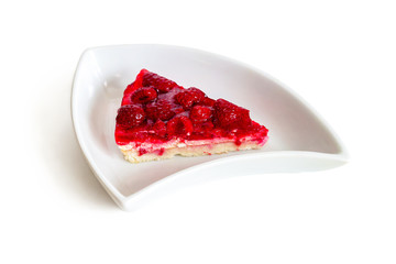 A piece of raspberry pie in a triangular dish