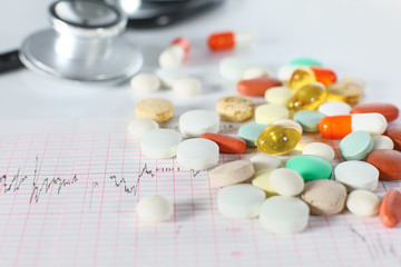 stethoscope, pills, vials in medical room on blue background top view mockup