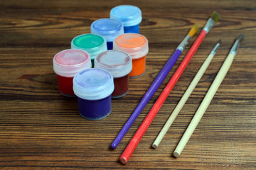Gouache colors and brushes are ready for painting