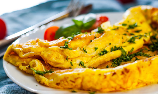 omelette in a white plate on wooden table