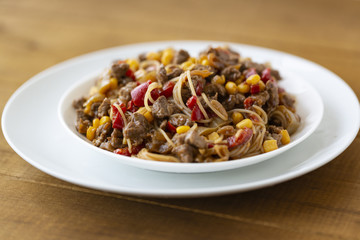 Noodles with meat and vegetables  in sweet and sour sauce.