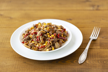 Noodles with meat and vegetables  in sweet and sour sauce.
