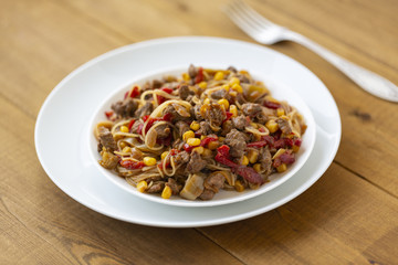 Noodles with meat and vegetables  in sweet and sour sauce.