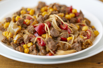 Noodles with meat and vegetables  in sweet and sour sauce.