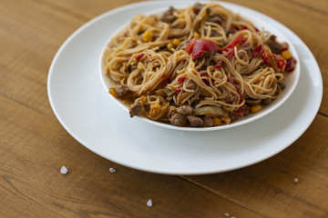 Noodles with meat and vegetables  in sweet and sour sauce.