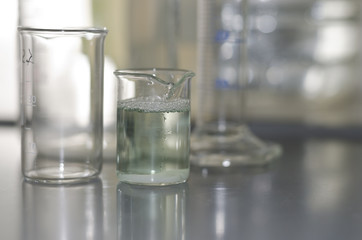 Sample of water in glass tube with green coloring gradient