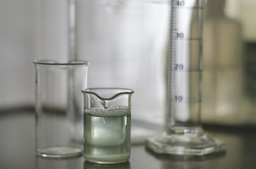 Sample of water in glass tube with green coloring gradient