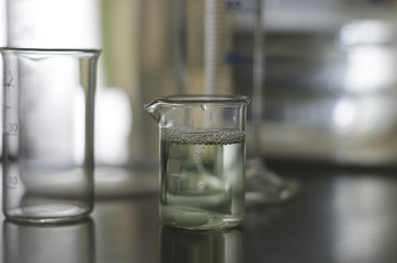Sample of water in glass tube with green coloring gradient