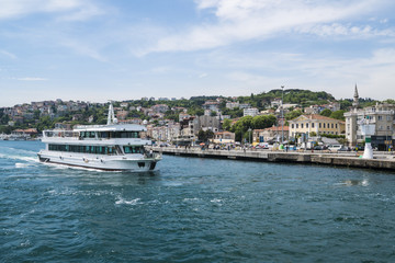 Fototapeta na wymiar Beautiful View of Bosphorus Coastline in Istanbul with Exquisite wooden Houses and Boat
