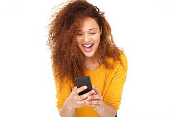 Close up cheerful young woman laughing with mobile phone against isolated white background