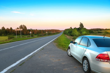 Fototapeta na wymiar landscape with sunset, road and car