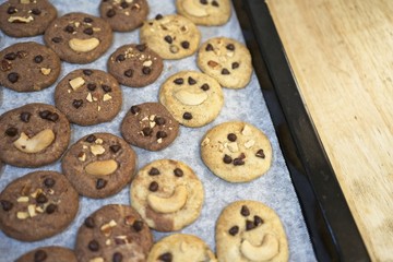 Delicious Chocolate Chip Cookies on baking tray and on wooden table, Top view of Tasty Homemade cookies