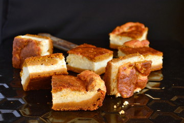 Cottage cheese and pumpkin pie on a black background