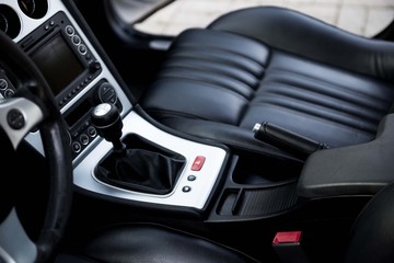 Obraz na płótnie Canvas Luxury sport car interior. Car leather seats with gear box