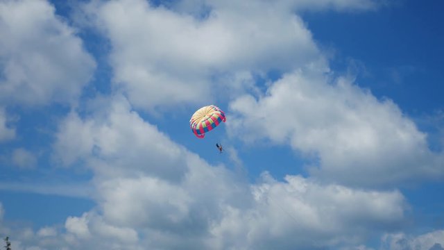 parasailing playing on sky over beach