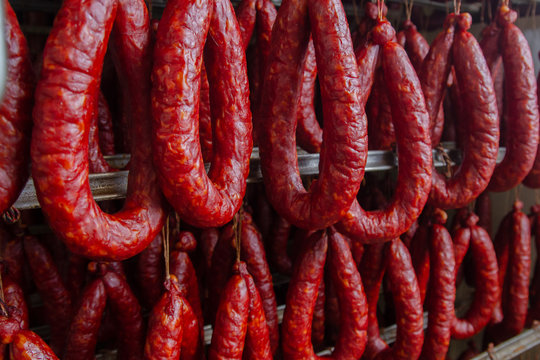 Sausage. Sausage production line. Sausage on the counter for the smokehouse. Industrial manufacture of sausages. Meat shop