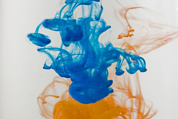 Color paint drops in water. Ink swirling underwater.