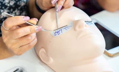 basic training to build eyelashes on a silicone mannequin. Work with tweezer, close up