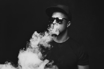 Vaping man and a cloud of vapor