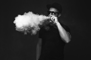 Vaping man and a cloud of vapor