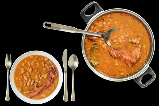 Gourmet Baked Beans Cooked with Smoked Pork Ribs Served in Large Saucepot and Porcelain Plate Isolated on Black Background
