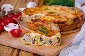 Baked pancakes (crepes) with mushrooms and bechamel sauce