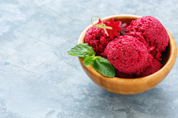 Homemade beetroot ice cream in a wooden bowl.