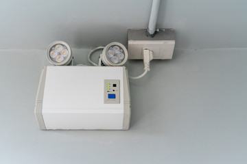 emergency light auto lighting working when power outage by battery against white wall