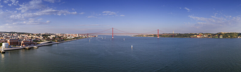 Aerial panoramic view of the city of Lisbon with sail boats on the Tagus River and the 25 of April...