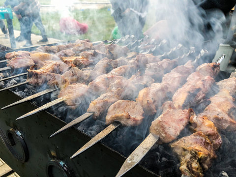 Mcvadi - shashlik preparing on a barbecue grill over charcoal. Roasted stacked meat Shish kebab popular in Goergia. Traditional cuisine in Georgia