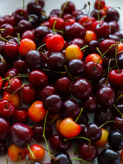 Cherries on wooden table with water drops macro background