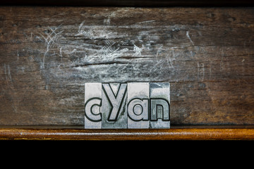 Cyan made with metalic types on a shelf