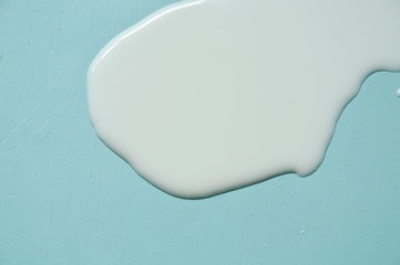 fresh white splatter on blue table background